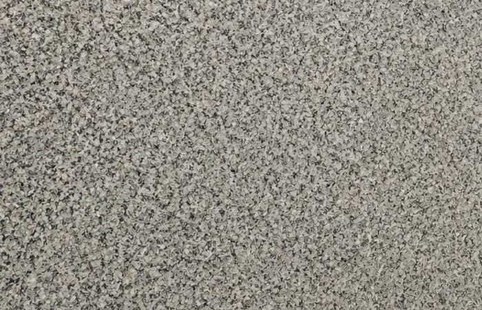 Apple Green granite: a sage green-grey polished surface with a dense speckled grain of dark and light minerals