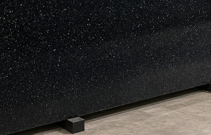 Galaxy Black granite: a deep black polished slab scattered with fine copper-gold flecks, like stars