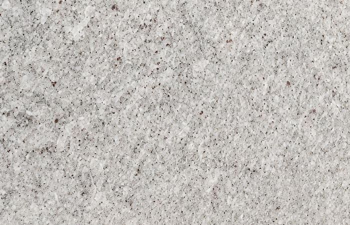 Kashmiri White granite: a frost-white polished surface with fine grey and rose mineral flecks