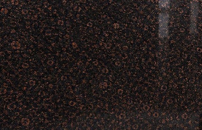 Madampally granite: fine coffee-brown rosettes evenly scattered on a polished black ground