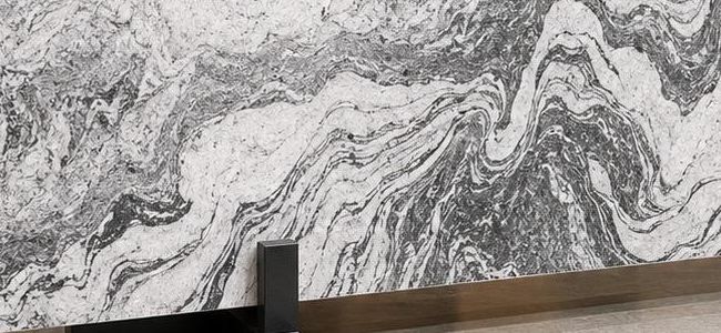 Viscon White granite: bright white surface with flowing grey and charcoal swirls, like a river in stone